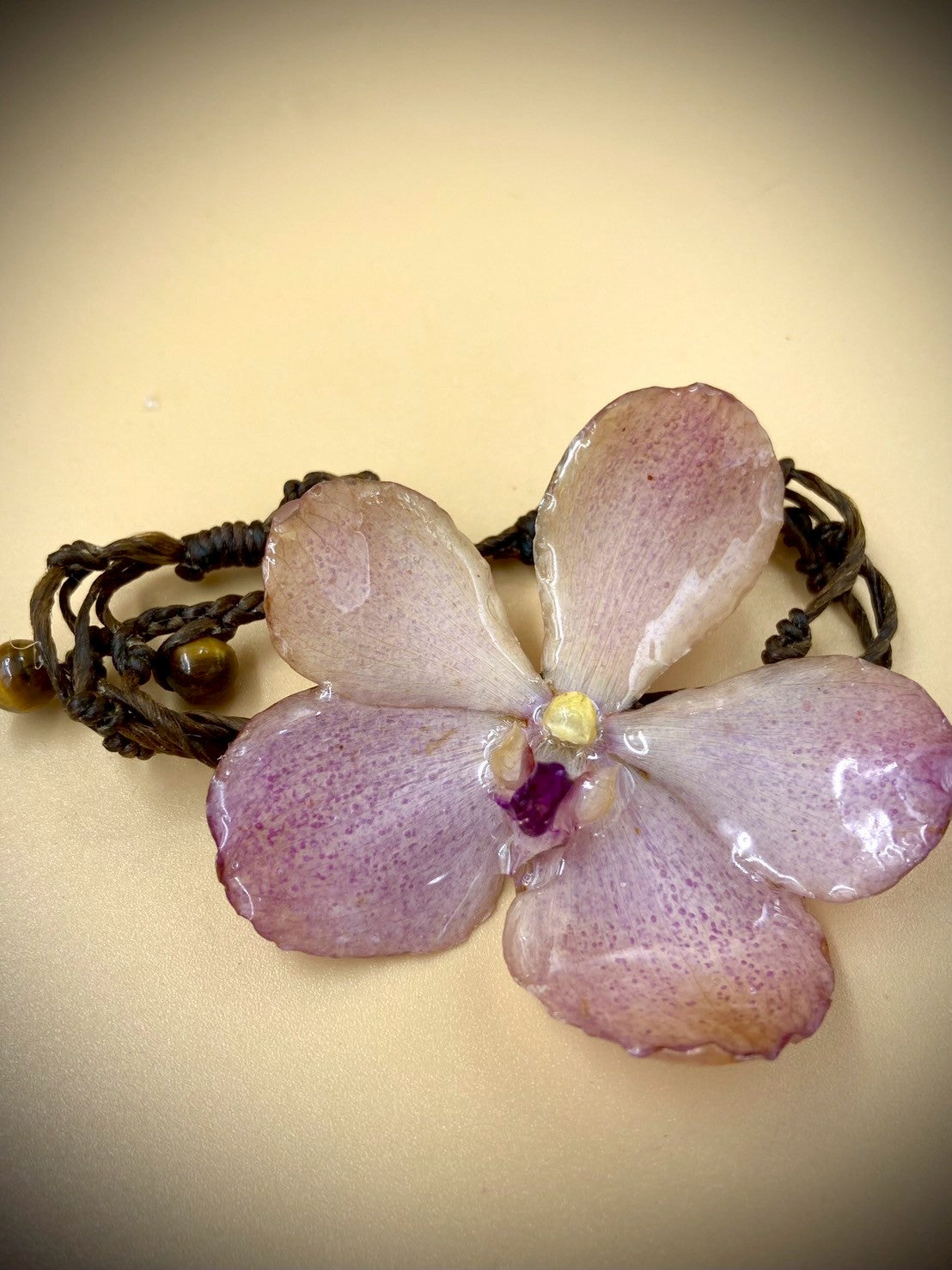 Bracelet made from real orchids, dark brown string