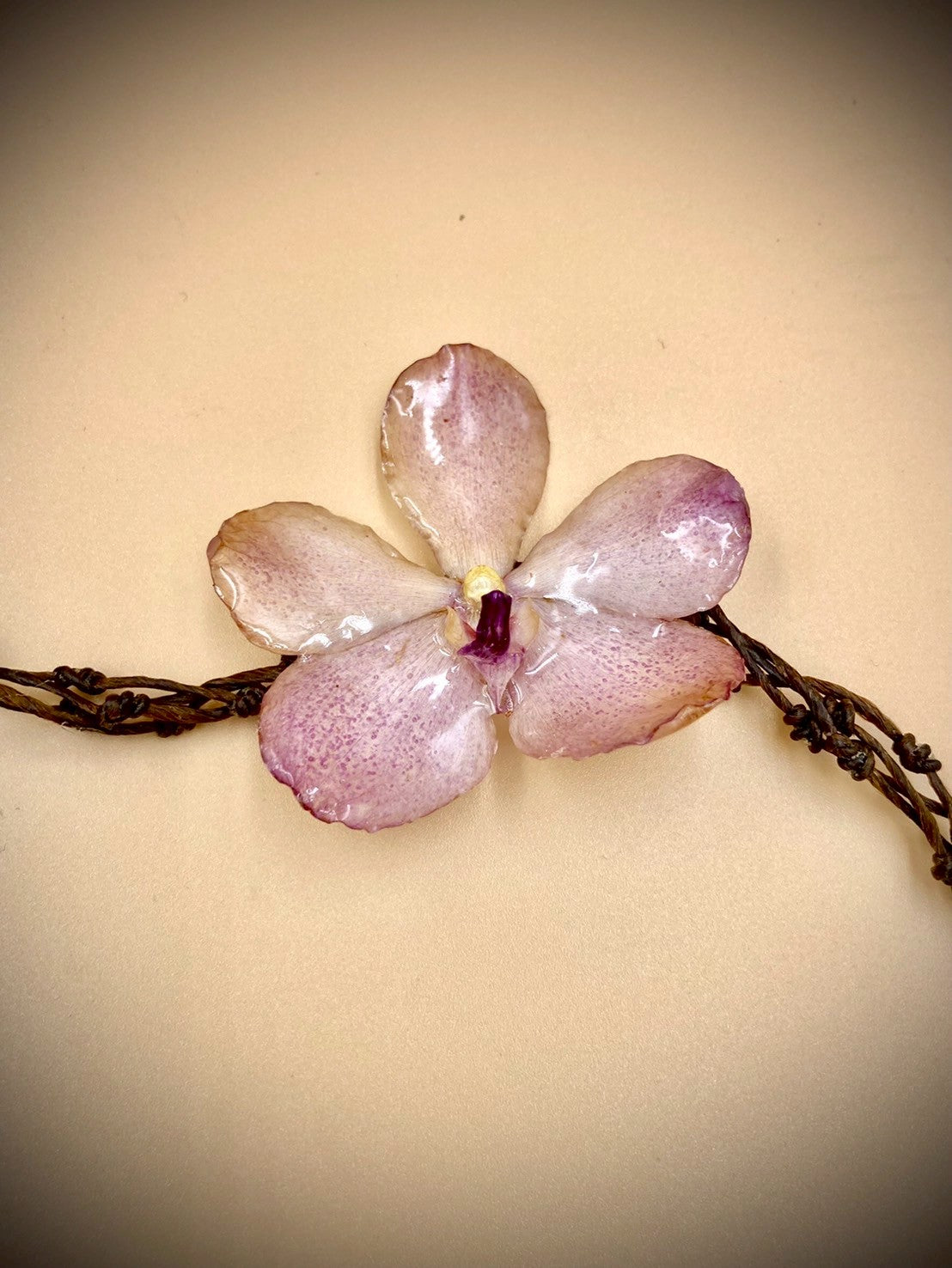Bracelet made from real orchids, dark brown string