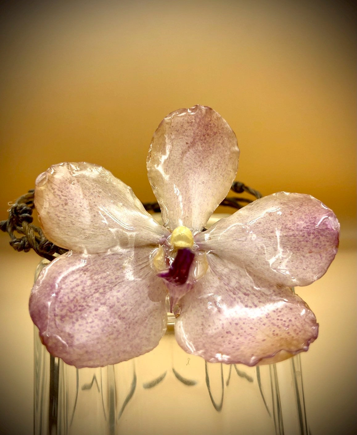 Bracelet made from real orchids, dark brown string